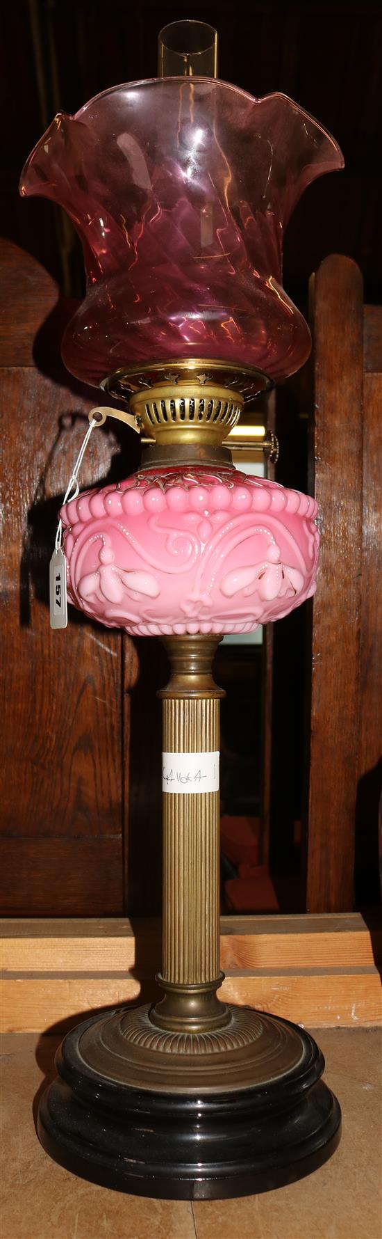 Victorian oil lamp with pink opaque oil reservoir & cranberry shade